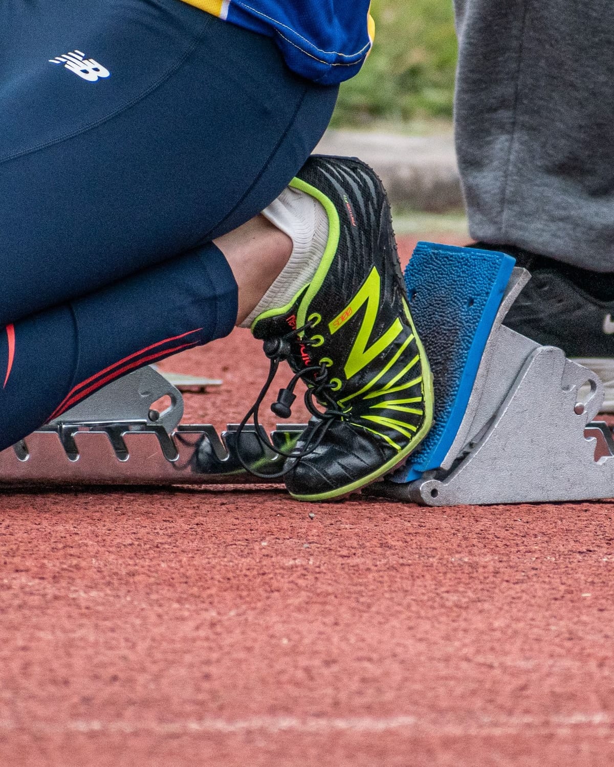 A sprinter's feet set in starting blocks on a track