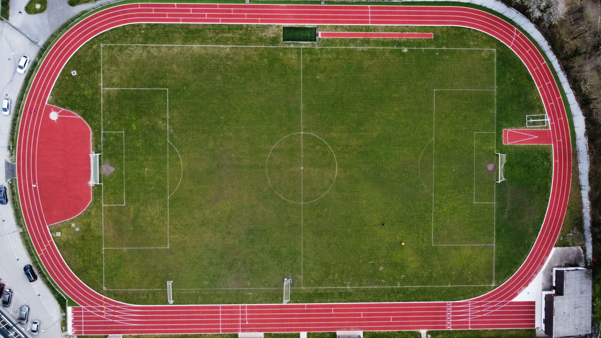 An aerial view of an athletics track around a pitch