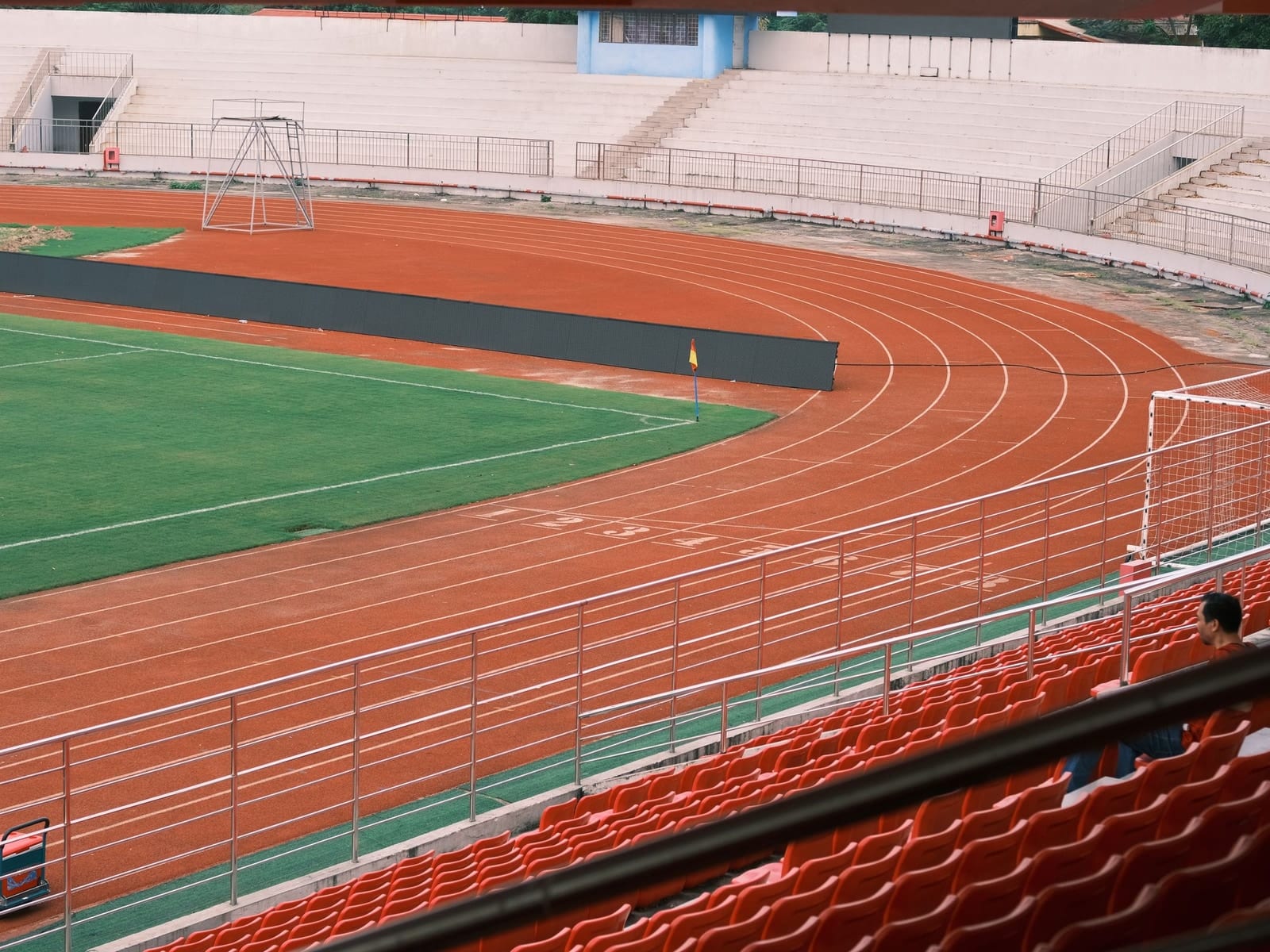 Empty stadium seating above an athletics track